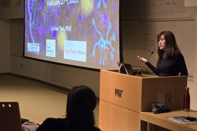 Li-Huei Tsai gestures as she speaks at a lectern