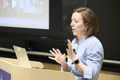 Emily Knight speaks at a lectern