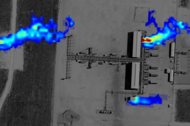 An overhead satellite image of a gas production site, with plumes of gas (colored to show concentration levels) emanating from 3 locations.