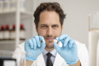 Aron Blaesi with two spherical, lattice-like pills.