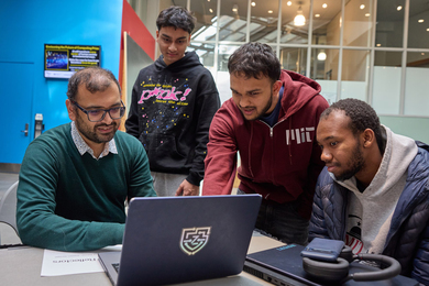  Mohammed Ihtisham, Arvind Satyanarayan, Nayeemur Rahman, and Alqasem Senegali huddle around an open laptop