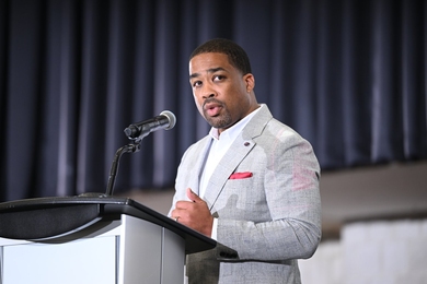 G. Anthony Grant speaks at a lectern indoors