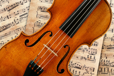 A Stradivarius violin resting on sheet music