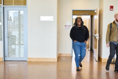 Alecia Asiamigbe walks out of a classroom into a hallway