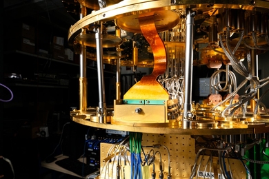 A complex assemblage of cables and wires in a sturdy circular frame is shown with a bending copper band as one of the components.