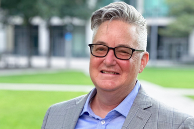 Chris Bourg headshot with MIT couryard in the background