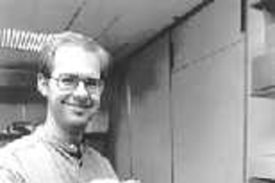 Graduate student Mark Ottensmeyer displays the latest version of PHANToM. Depending on which wall of the square represented on the computer screen one "touches" with the PHANToM, the sensation of hot, cold or a neutral temperature will be felt by the user.