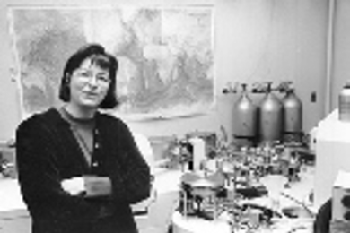 Maureen Raymo, associate professor of earth, atmospheric and planetary sciences, with a mass spectrometer into which core samples from her sediment-drilling expedition are placed for analysis.
