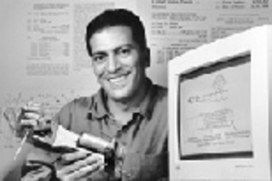 Daniel DiLorenzo with one of his first inventions, a robotic arm measured to his own hand and fingers.