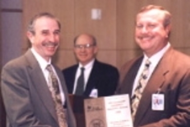 JOINING FORCES--MIT Professor Alan V. Oppenheim (left) with Thomas J. Engibous, Chairman, CEO and President of Texas Instruments (right) and TI DSP research director Bob Hewes. MIT, Rice University and Georgia Tech are each receiving $1 million from TI to establish a collaborative research network in advanced digital signal processing. Professor Oppenheim will oversee the project at MIT.