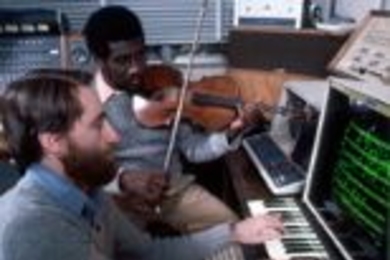 Professors Barry Vercoe and Marcus Thompson working in front of a graphical score editor, circa 1976.