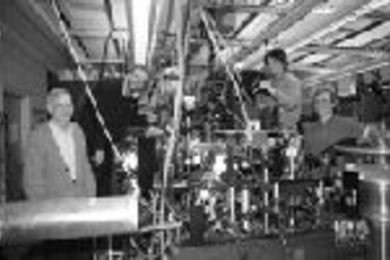 Physics Professors David Pritchard (far left) and Wolfgang Ketterle (far right) watch as visiting scientist Tilman Pfau (second from left) and Shin Inouye, a graduate student student in earth, atmospheric and planetary sciences (second from right) align mirrors on the lab's newest atom laser.