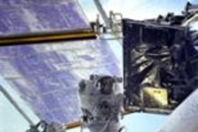 NASA astronaut John M. Grunsfeld (SB 1980) conducts a space walk during last month's space shuttle mission to repair the Hubble Space Telescope. Dr. Grunsfeld is at the end of Discovery's remote manipulator system as he prepares to replace a radio transmitter in one of Hubble's electronics bays.