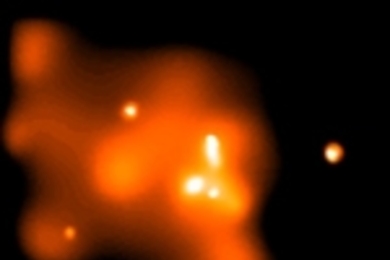 This Chandra X-ray image of the innermost 10 light years at the center of our galaxy has been smoothed to bring out the X-ray emission from an extended cloud of hot gas surrounding the supermassive black-hole candidate Sagittarius A* (white dot at the center of the image).