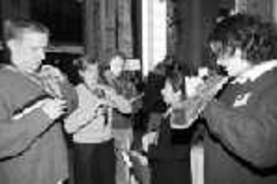Charm School offered lessons in all sorts of useful things, including how to tie a tie. Jen Frank, a senior in biology (right) and Norma Lopez (second from right) give instruction to Brian Pasquinelli, a senior in chemical engineering (far left) and Sara Copeland (SB 1999).