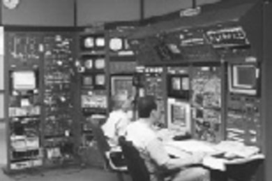Assistant Operations Group Leader Larry O'Brien (right) and Chief Operator Larry Longcoy tune the electron linear accelerator from the Bates central control room. Recent upgrades to the accelerator radio frequency system have made it possible to produce a beam of electrons at an energy of one billion electron volts.