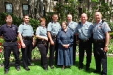 Campus Police officers and a paramedic joined Mrs. Becky Vest at the President's House last week to receive commendations for saving her life. Left to right: paramedic Chris Wozney, Officer Michael E. Carey, Sgt. Janet Popp, Officer Mark R. Kelleher, Mrs. Vest, and Officers Michael R. DeBenedictis, Kevin M. O'Connor and Brent J. Nelson.