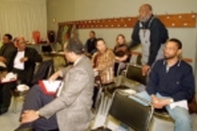 Mel King (standing), former director of the Community Fellows Program (now CRCP), speaks at "In Search of Community: From Knowledge for Profit to Competitive Intelligence."