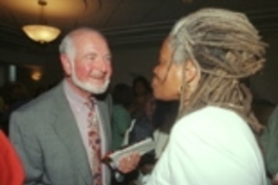 Above, Medical Director Arnold Weinberg chats with pediatrician Janet Moses at his retirement party, where he was roasted by friends and colleagues who at one point displayed an "American Gothic" view of Dr. Weinberg in front of the podium (right).
