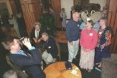 Ted Johnson (left) of the Campus Activities Complex takes a photo of retirement dinner guests. Posing with the MIT beaver mascot are (left to right) Professor of Literature Travis Merritt; Nita Regnier, instructor in the Program in Writing and Humanistic Studies; and Bonnie Walters, associate dean in the Office of Academic Services.