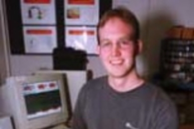 Stephen Mascaro, a graduate student in mechanical engineering, displays a fingernail sensor designed to replace input from a keyboard or mouse.