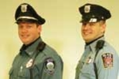 MIT Campus Police Officer Willard J. Boulter III (left) sports the department's new uniform, side by side with Officer Peter M. McTague, who's still wearing the old one.