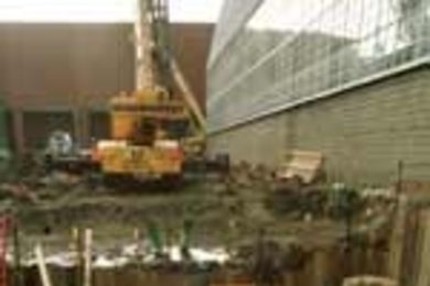 Workmen at the Zesiger Athletic Center work on footings and an elevator shaft. (The Johnson Athletics Center is in the background and Rockwell Cage is at right.)