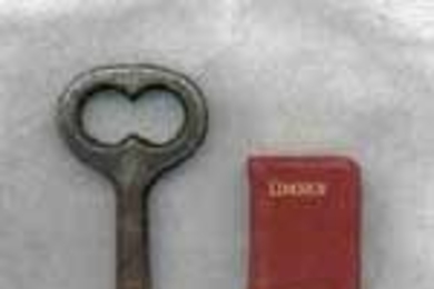 The key measures 2 and 9/16 inches high. The book is 13/16 of an inch high by 9/16 of an inch wide.