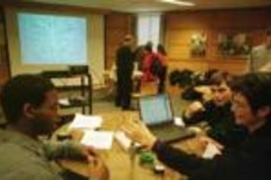 In one of last week's MacVicar Day teaching demonstrations, Leonard Grant (left), a junior in materials science and engineering, and freshman Daniel Garcia (center) explain Faraday's Law of Induction to alumna Lissa Martinez (right), who earned the SB in ocean engineering in 1976. They're using a desktop experiment from Professor John Belcher's TEAL Project that will be implemented in the fall in ...
