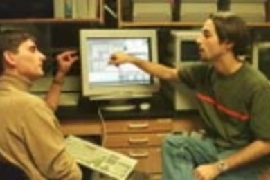 Professor Jesus del Alamo (left) converses with electrical engineering junior James Hardison in front of the WebLab system in Professor del Alamo's lab.