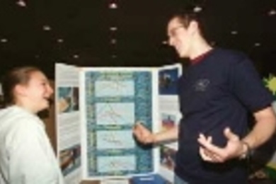 Freshman Jon Varsanik (right), a swim team member, chatted with Francesca Izzo of Graham and Parks School, another swimmer, about her study on the science of swimming.