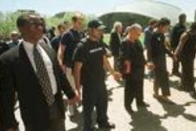 MIT community members including (left to right) Dean Isaac Colbert, sophomore Devang Kothari of Alpha Tau Omega, Dean Ayida Mthembu, Tang Hall housemaster Dawn Anderson and senior Aisha Stroman hold hands at Tuesday's "Speak Out!!" rally.