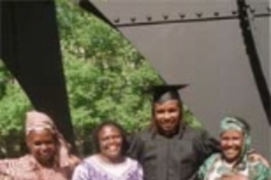 Kirimania Murithi with his three mothers in front of the The Great Sail in McDermott Court. Left to right: Kanugu Mbaya, the midwife who delivered him; Faith Anampiu, who provided a home for him when he attended the Alliance School in Nairobi; and his birth mother, Elizabeth Njiru.