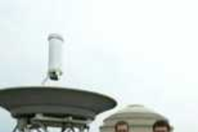 Postdoctoral associates Vittorio Giovannetti (left) and Lorenzo Maccone (right) published work in Nature with Professor Seth Lloyd about a quantum positioning system that could replace the global positioning systems in the future. The two researchers stand next to a parabolic antenna on the roof of Building 26.