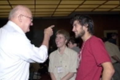 MIT Professor of Mathematics Alar Toomre (left) regales University of Cambridge students Adam Steventon (center) and Daniel Abramson at a brunch given in honor of their arrival for a year's study at MIT.