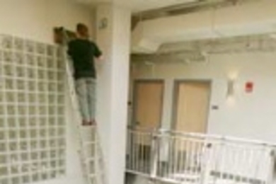 Workmen put some finishing touches on the inside of the new graduate residence at 224 Albany St.