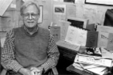 Kenneth Hale posed in 1995 with some of the dictionaries and grammar books he compiled of near-extinct languages in Nicaragua, Australia and other locations.