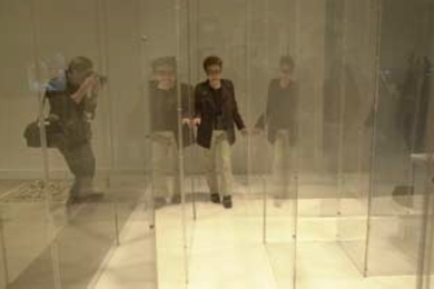 A photographer snaps away as artist Yoko Ono makes her way through a maze that's part of the "YES Yoko Ono" exhibit now showing at the List Visual Arts Center.