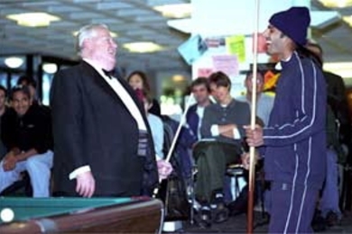 Anish Parikh shares a laugh with pool expert Jack White at White's Student Center demonstration.