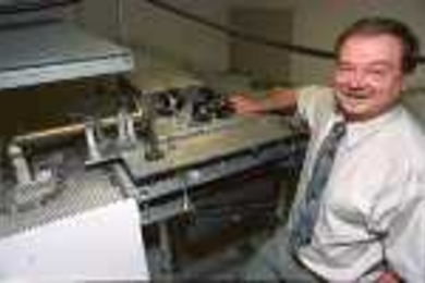 Paul Woskov shows off the MilliWave Viscometer, which won him his fifth R&amp;D 100 award.