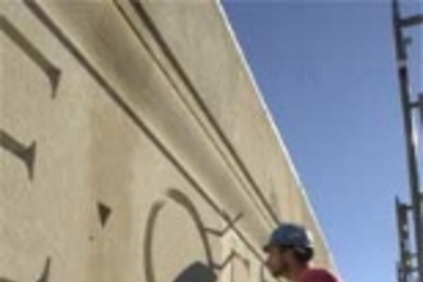 Jerry LeBlanc of Phoenix Baystate fits a stone in place over the 77 Massachusetts Ave. entrance, where the damaged facade is being repaired. For other construction photos and updates, see page 5.