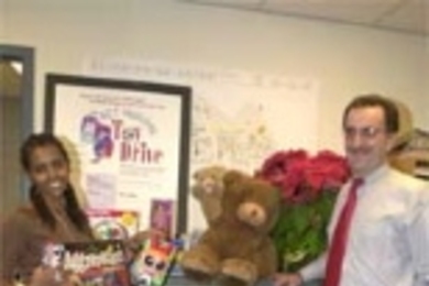 A toy drive sponsored by the Campus Police and the Parking and Transportation Office allowed people to donate toys in lieu of paying parking tickets. Hazeb Adugna (left) and Larry Brutti of Parking and Transportation look at some of the donated toys.