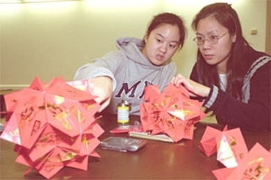 To prepare for the Chinese Students  Club's annual Chinese New Year's banquet next month, Kathy Li '05, one of the  co-coordinators of an IAP craft-making course, works with Yvonne Xiang, whose  husband Hong Xiang is a postdoc associate at the Laboratory for Nuclear Science.