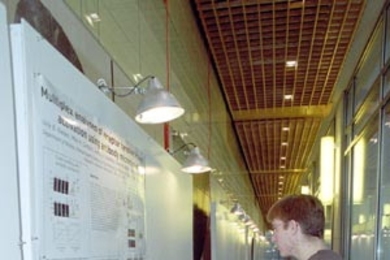 John Albeck, a graduate student in cellular biology, and Suzanne Gaudet,        a postdoctoral fellow in biology, prepared for the poster competition at        the symposium held in honor of MIT's new BioMicro Center (see MIT        Tech Talk, Jan. 9 ). The Jan. 11 symposium, "Computational and Systems Biology: From Biofabrication to Bioinformatics," was the first of what will become an annual eve...