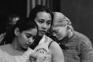 Sophomore Rosa Obregon of aeronautics and astronautics (left), junior Kim Nguyen of electrical engineering and computer science (center), and freshman Hillary Stanton portray immigrants trying to reach America in a boat lost at sea in a rehearsal for "Seachange."