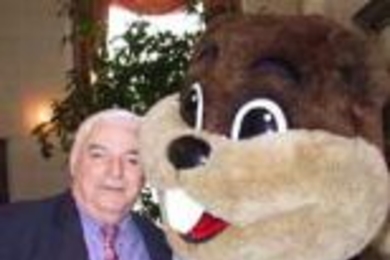 Paul Honiker, a campaign solicitor for the Controller's Accounting        Office, poses with the MIT beaver at a celebration hosted by Mrs. Rebecca Vest on Feb. 6.