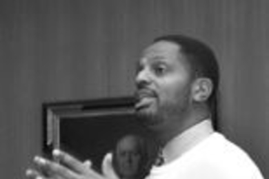 Karl Reid, executive director of special programs at MIT, addresses local        students and their parents during an orientation session Thursday on SEED, a new educational program for high school students.