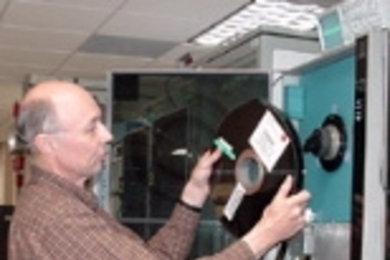 Dr. Alan Whitney of Haystack mounts an 18,000-foot tape on the Mark IV correlator. Magnetic tapes will be eliminated when the e-VLBI program is finished.