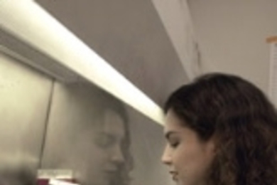 Elsa Flores, a postdoctoral associate, works with cell cultures under the        hood in Tyler Jacks' lab. Flores and Jacks recently identified genes        involved in cellular suicide that may be key in cancer research.