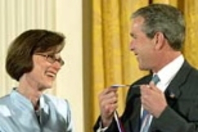 President Bush presents the National Medal of Science to Ann M. Graybiel from  MIT during a ceremony in the East Room of the White House, Wednesday, June 12,  2002.